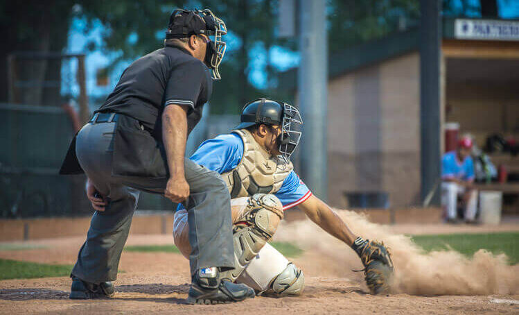 Baseball game in Boulder, Colorado, showing players on the field under a clear sky.